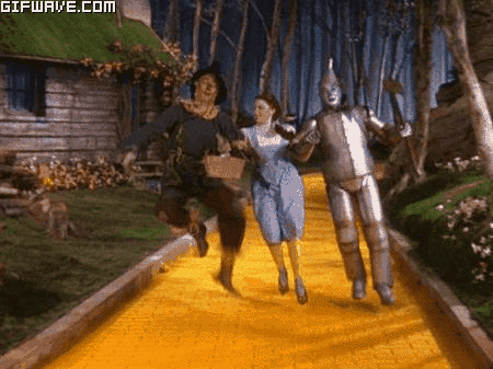 wizard-of-oz-scarecrow-dorothy-gale-tin-man-skipping.gif
